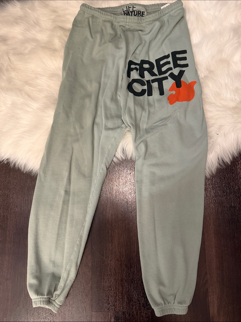 freecity Kids Sage Green Sweatpants with Black Logo and Orange Accent